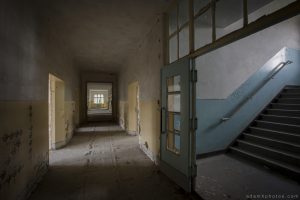Adam X Urbex Urban Exploration Abandoned Germany Wunsdorf barracks soviet corridor stairs staircase decay colours yellow blue